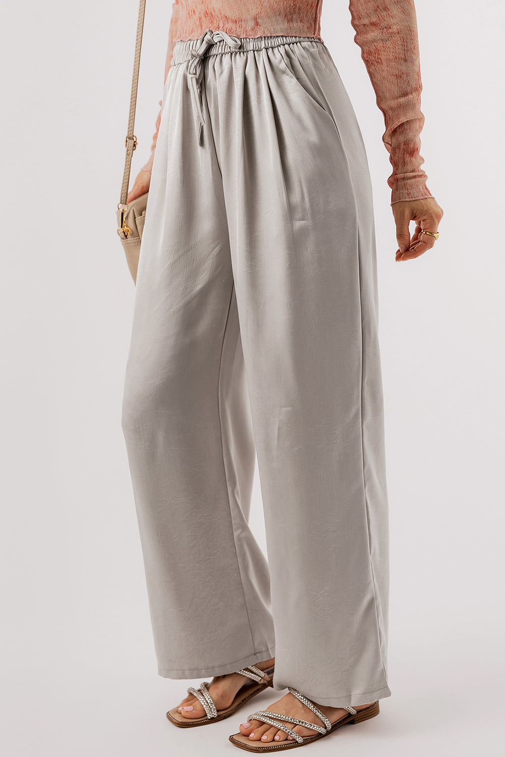 Jet Stream Solid Pleated Drawstring High Waist Wide Leg PantsMaterial:100%Polyester

• Elevate your wardrobe with the pants, designed for all-day comfort and style.
• The pleated detailing adds a touch of sophistication, whi