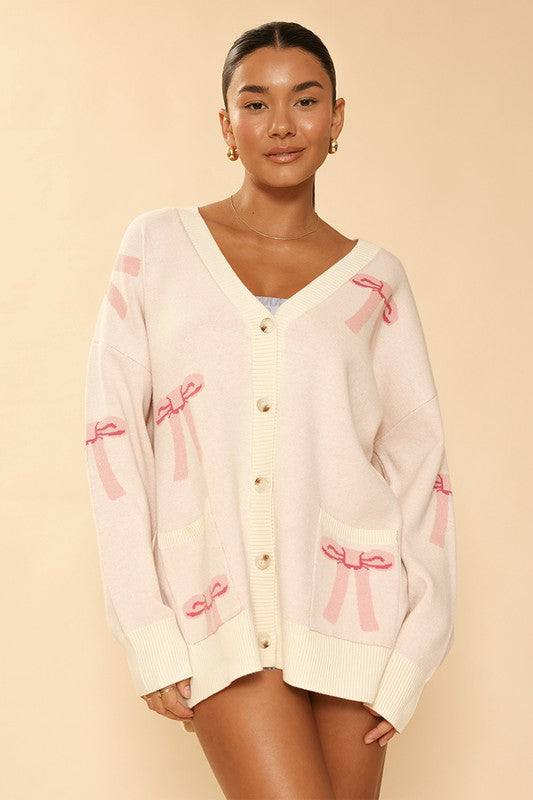 All over bow knit cardigan*Exclusive In-House Design*-All over bow intarsia-V-Neck-Button front-Front patch pockets-All original design-Oversized