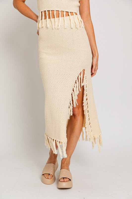 Tassel Detail Sweater Midi SkirtIntroducing our Tassel Detail Sweater Midi Skirt, a chic and versatile piece for your wardrobe. This midi skirt features stylish tassel details along the hem, adding