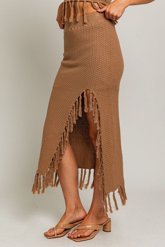 Tassel Detail Sweater Midi SkirtIntroducing our Tassel Detail Sweater Midi Skirt, a chic and versatile piece for your wardrobe. This midi skirt features stylish tassel details along the hem, adding