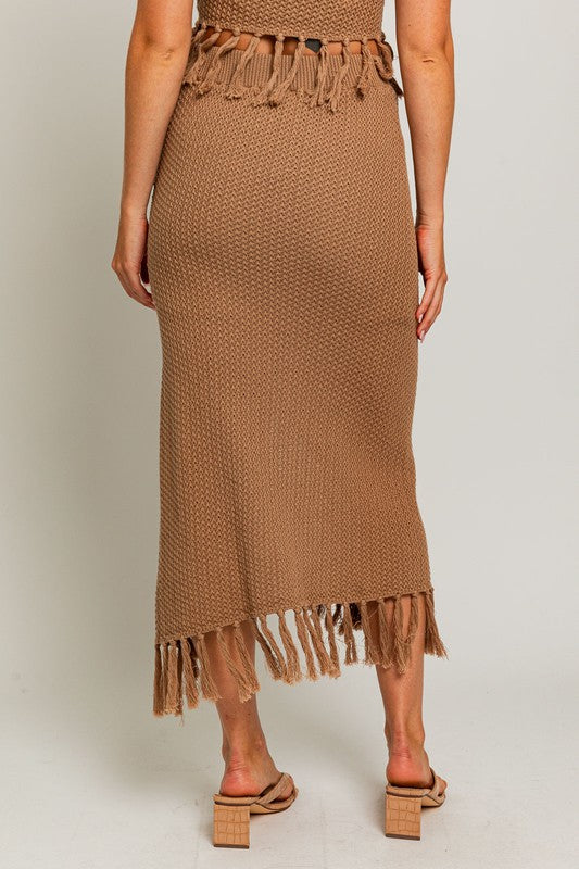 Tassel Detail Sweater Midi SkirtIntroducing our Tassel Detail Sweater Midi Skirt, a chic and versatile piece for your wardrobe. This midi skirt features stylish tassel details along the hem, adding