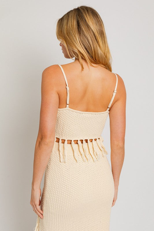 Tassel Detail Spaghetti Sweater Crop TopA playful and trendy addition to your wardrobe that adds a touch of boho flair to your outfit. This crop top features tassel details along the spaghetti straps, crea