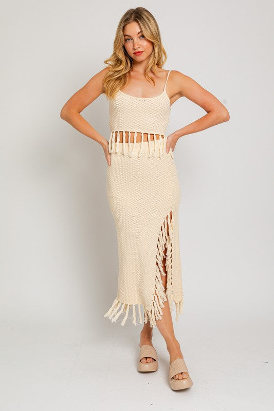 Tassel Detail Spaghetti Sweater Crop TopA playful and trendy addition to your wardrobe that adds a touch of boho flair to your outfit. This crop top features tassel details along the spaghetti straps, crea