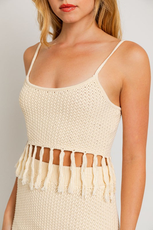 Tassel Detail Spaghetti Sweater Crop TopA playful and trendy addition to your wardrobe that adds a touch of boho flair to your outfit. This crop top features tassel details along the spaghetti straps, crea