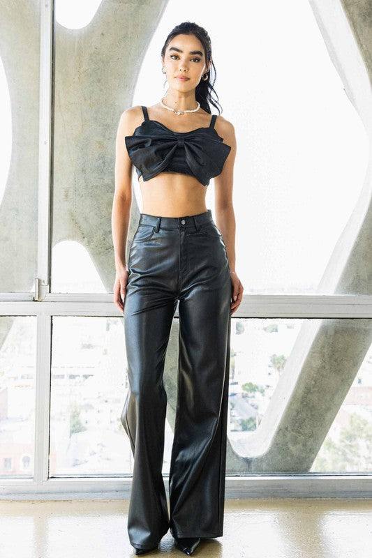 Vegan Leather Wide Leg PantsIndulge in cruelty-free chic with our Vegan Leather Wide Leg Pants. Crafted from high-quality PU, these pants showcase a modern edge with two front and back pockets,