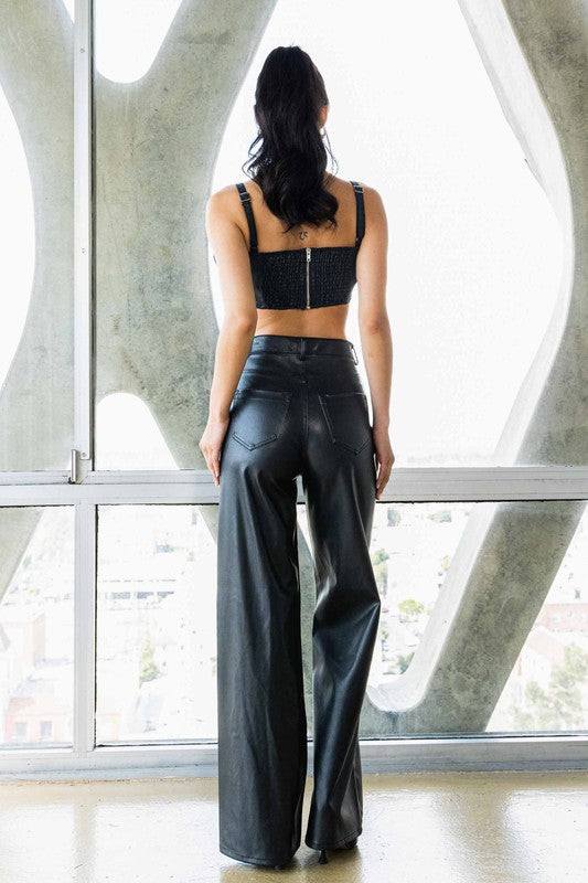 Vegan Leather Wide Leg PantsIndulge in cruelty-free chic with our Vegan Leather Wide Leg Pants. Crafted from high-quality PU, these pants showcase a modern edge with two front and back pockets,