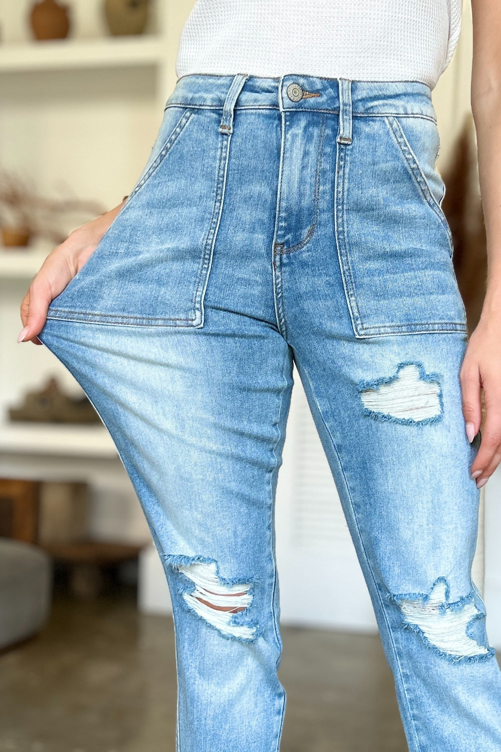 Judy Blue Full Size Distressed Straight Jeans with Patch PocketsThese distressed straight jeans feature stylish patch pockets for added flair. The distressed detailing adds a trendy touch to your look. The straight cut offers a f