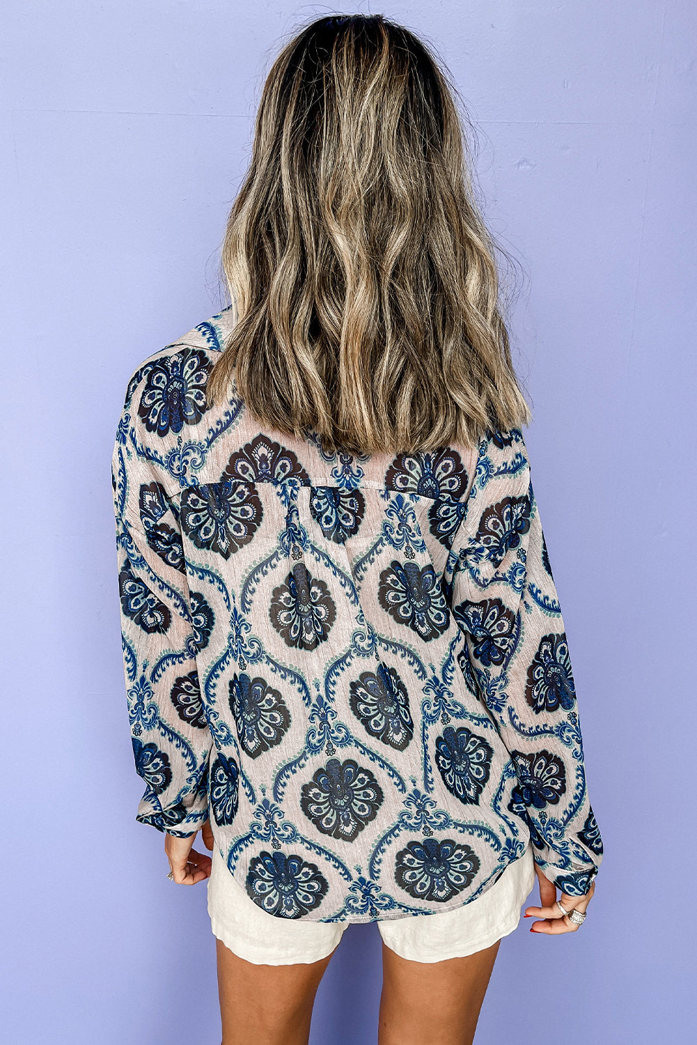 Blue Ethnic Print Button V Neck Loose ShirtMaterial:100%Polyester

• Embrace a blend of cultures with the shirt, featuring a unique blend of bohemian and abstract patterns. 
• Effortlessly stylish with its 