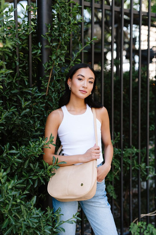 MARISA CROSSBODY SLING PURSE HANDBAGMade from buttery-soft vegan leather and glossy gold hardware, the Marissa Crossbody is the epitome of quiet luxury. This stunning saddle bag transforms seamlessly f