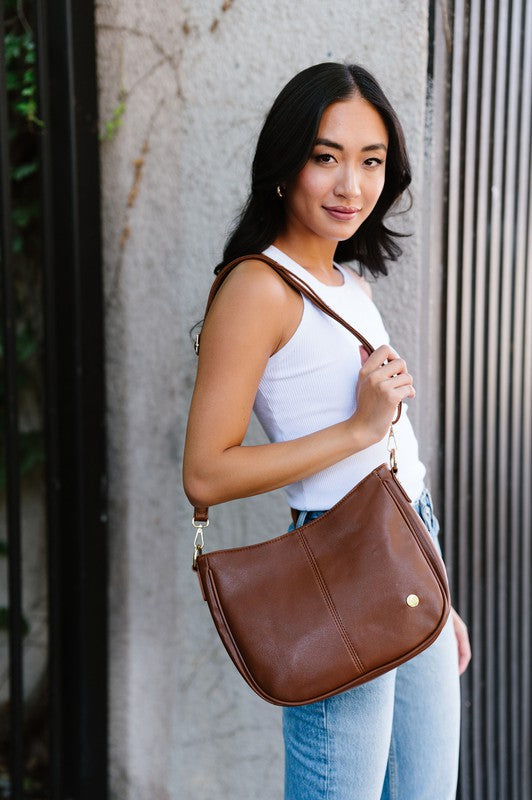 MARISA CROSSBODY SLING PURSE HANDBAGMade from buttery-soft vegan leather and glossy gold hardware, the Marissa Crossbody is the epitome of quiet luxury. This stunning saddle bag transforms seamlessly f