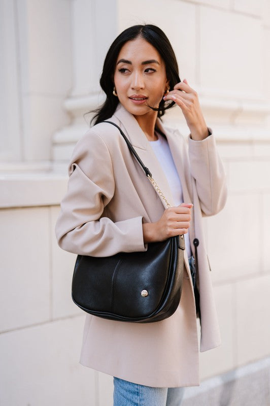 MARISA CROSSBODY SLING PURSE HANDBAGMade from buttery-soft vegan leather and glossy gold hardware, the Marissa Crossbody is the epitome of quiet luxury. This stunning saddle bag transforms seamlessly f