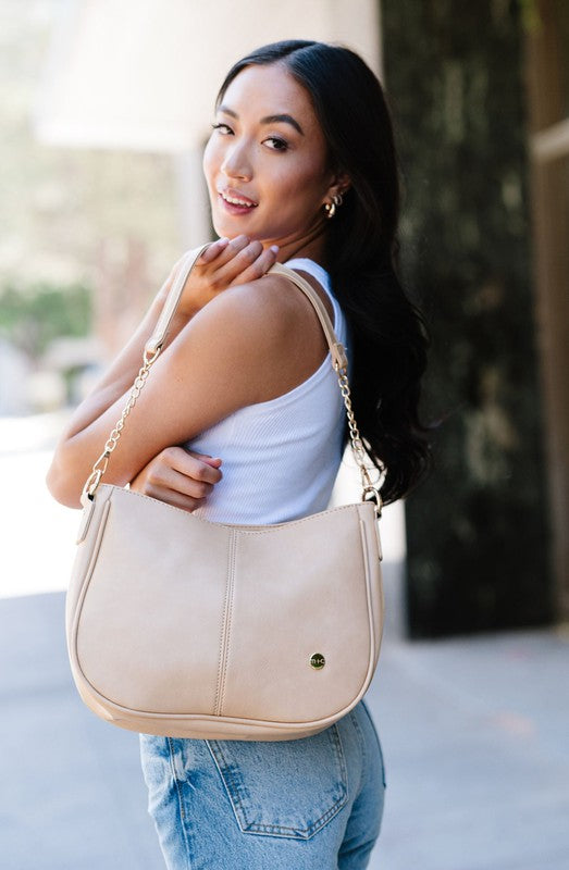 MARISA CROSSBODY SLING PURSE HANDBAGMade from buttery-soft vegan leather and glossy gold hardware, the Marissa Crossbody is the epitome of quiet luxury. This stunning saddle bag transforms seamlessly f