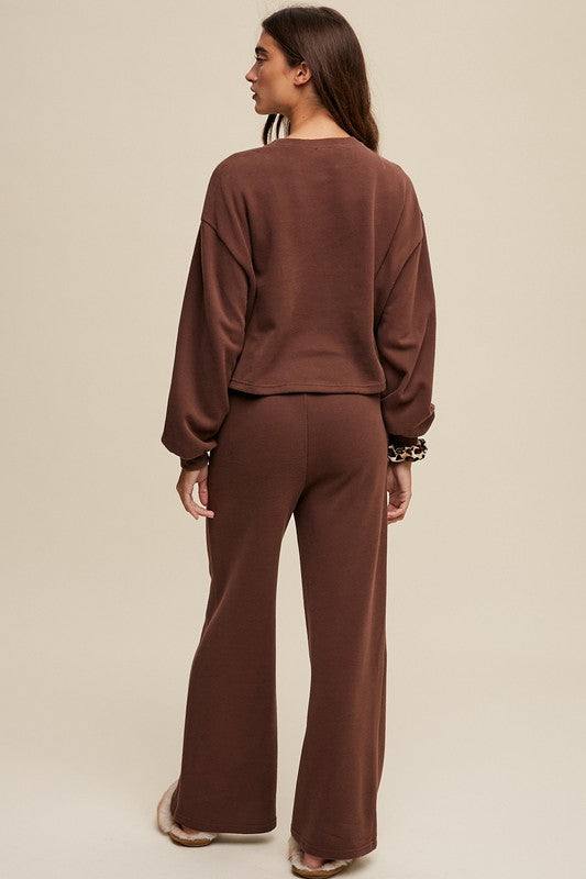 Knit Sweat Top and Pants Athleisure Lounge SetsElevate your loungewear game with our Knit Sweat Top and Wide Leg Pants Athleisure Lounge Set. The cozy knit sweat top features a classic round neck and long sleeves