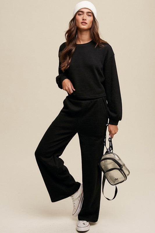 Knit Sweat Top and Pants Athleisure Lounge SetsElevate your loungewear game with our Knit Sweat Top and Wide Leg Pants Athleisure Lounge Set. The cozy knit sweat top features a classic round neck and long sleeves