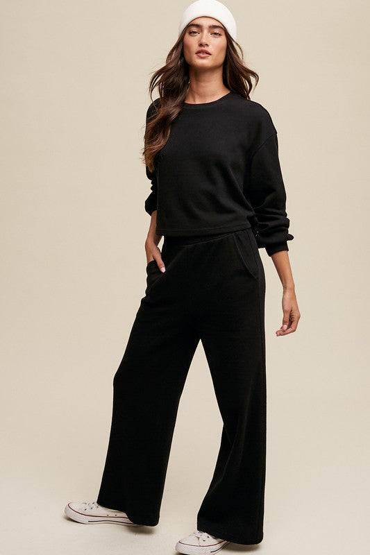 Knit Sweat Top and Pants Athleisure Lounge SetsElevate your loungewear game with our Knit Sweat Top and Wide Leg Pants Athleisure Lounge Set. The cozy knit sweat top features a classic round neck and long sleeves