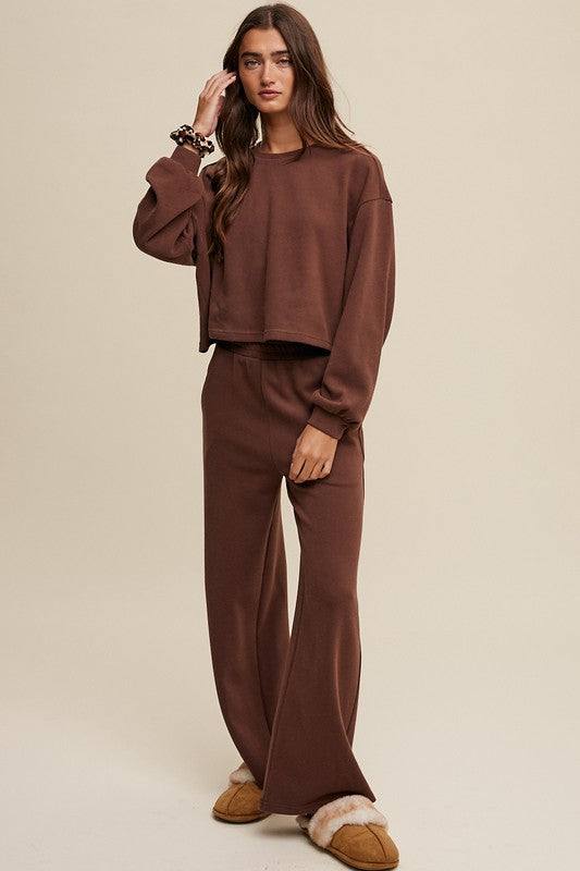 Knit Sweat Top and Pants Athleisure Lounge SetsElevate your loungewear game with our Knit Sweat Top and Wide Leg Pants Athleisure Lounge Set. The cozy knit sweat top features a classic round neck and long sleeves