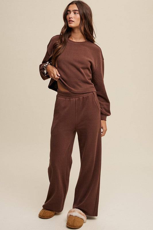 Knit Sweat Top and Pants Athleisure Lounge SetsElevate your loungewear game with our Knit Sweat Top and Wide Leg Pants Athleisure Lounge Set. The cozy knit sweat top features a classic round neck and long sleeves