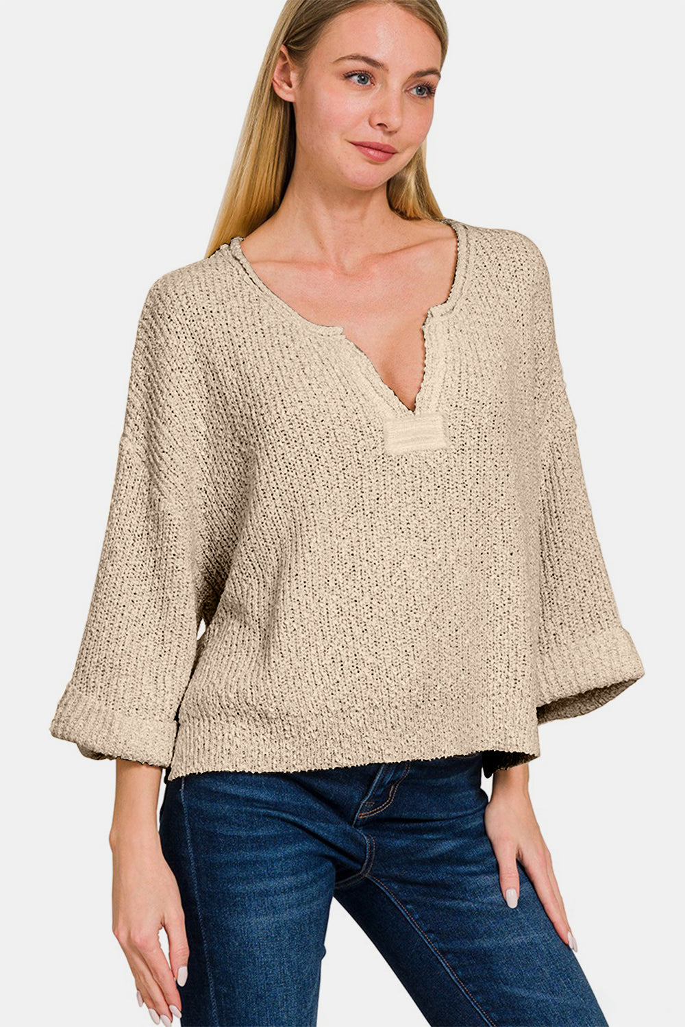 Zenana Notched Side Slit Patch SweaterThe notched side slit patch sweater is a trendy and unique addition to your knitwear collection. With its stylish notched design and side slits, this sweater adds a 