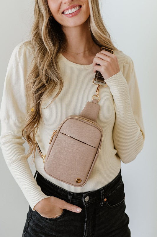 BRIDGET SLING CROSSBODY PHONE CASE BELT BAGIntroducing the Bridget Sling Crossbody-a chic and minimalist vegan leather bag, designed to be the perfect size to carry your daily essentials. Crafted with sleek l