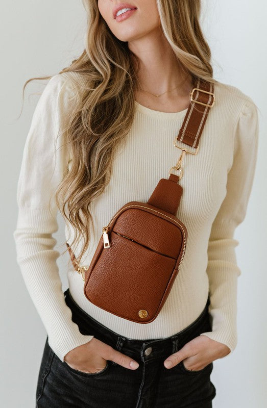 BRIDGET SLING CROSSBODY PHONE CASE BELT BAGIntroducing the Bridget Sling Crossbody-a chic and minimalist vegan leather bag, designed to be the perfect size to carry your daily essentials. Crafted with sleek l