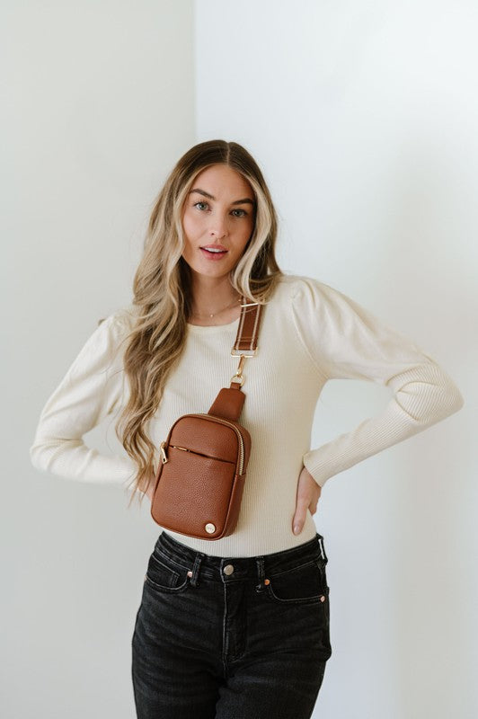 BRIDGET SLING CROSSBODY PHONE CASE BELT BAGIntroducing the Bridget Sling Crossbody-a chic and minimalist vegan leather bag, designed to be the perfect size to carry your daily essentials. Crafted with sleek l