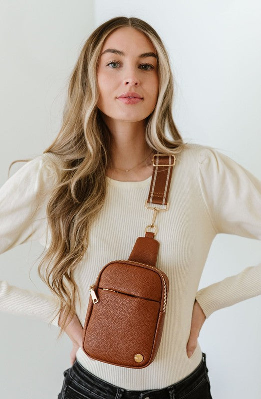 BRIDGET SLING CROSSBODY PHONE CASE BELT BAGIntroducing the Bridget Sling Crossbody-a chic and minimalist vegan leather bag, designed to be the perfect size to carry your daily essentials. Crafted with sleek l