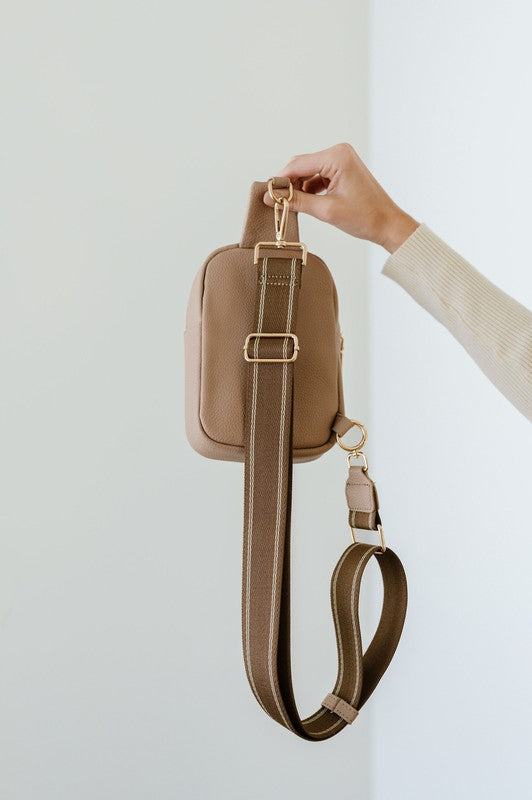 BRIDGET SLING CROSSBODY PHONE CASE BELT BAGIntroducing the Bridget Sling Crossbody-a chic and minimalist vegan leather bag, designed to be the perfect size to carry your daily essentials. Crafted with sleek l