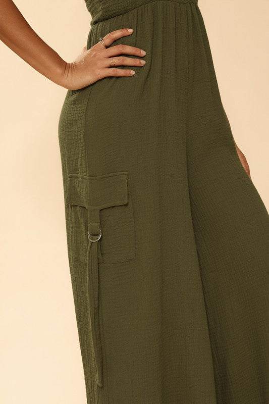 Smocked wide leg cargo jumpsuit*Exclusive In-House Design*-Smocked bodice-Self tie straps-Cargo pockets with d-ring detail-Wide legs-All original designMade In: China