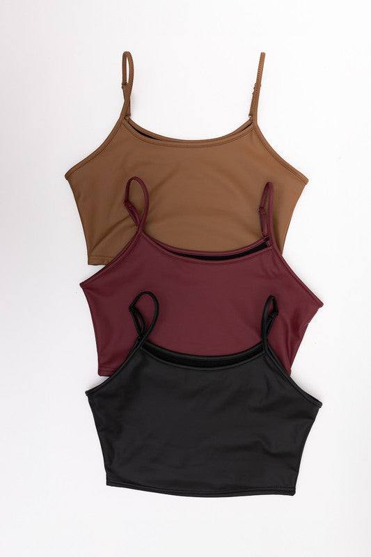 Strap Faux Leather Crop Cami TopFlaunt an audacious look with our Strap Faux Leather Crop Cami Top, a fashion-forward essential for your spring and summer wardrobe. Its faux leather finish and crop