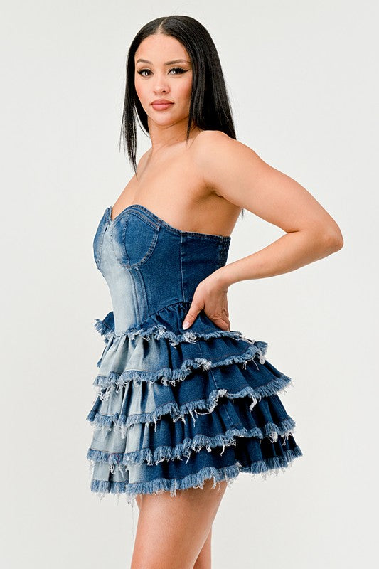 Denim Delight Tiered Ruffle DressIntroducing the "Denim Delight Tiered Ruffle Dress" - a playful and chic statement piece that combines the casual appeal of denim with the femininity of ruffles. Thi