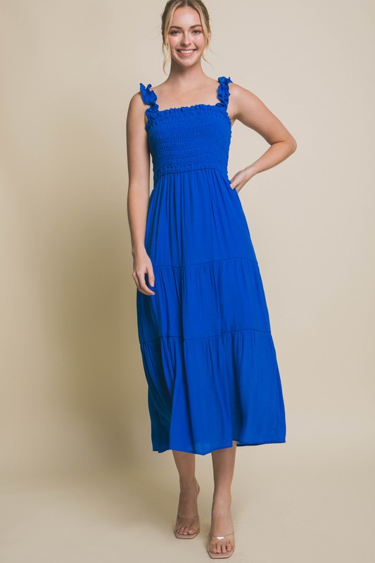 Smocked Bodice Maxi DressThe Smocked Bodice Maxi Dress is a charming and feminine piece perfect for various occasions. Its midi length, elastic strap, and smocked chest ensure a comfortable 