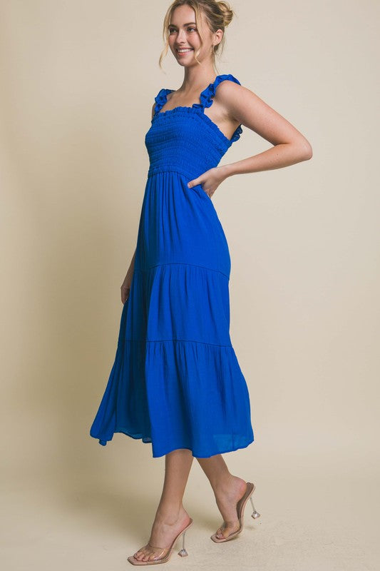 Smocked Bodice Maxi DressThe Smocked Bodice Maxi Dress is a charming and feminine piece perfect for various occasions. Its midi length, elastic strap, and smocked chest ensure a comfortable 