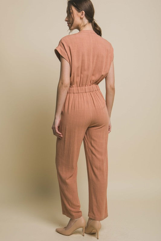 V-Neck Pocketed JumpsuitElevate your casual-chic style with our V-Neck Pocketed Jumpsuit. Crafted for both comfort and style, this jumpsuit features a flattering V-neckline that elongates t