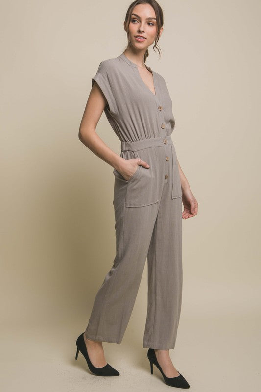 V-Neck Pocketed JumpsuitElevate your casual-chic style with our V-Neck Pocketed Jumpsuit. Crafted for both comfort and style, this jumpsuit features a flattering V-neckline that elongates t