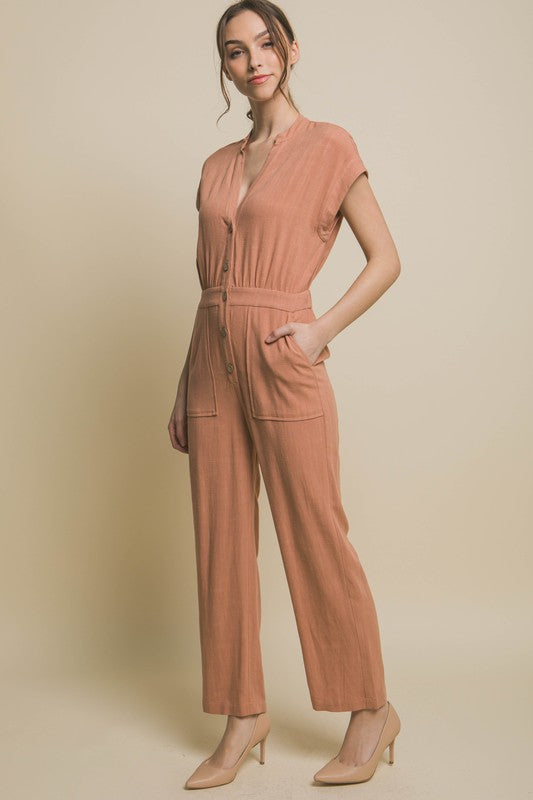 V-Neck Pocketed JumpsuitElevate your casual-chic style with our V-Neck Pocketed Jumpsuit. Crafted for both comfort and style, this jumpsuit features a flattering V-neckline that elongates t