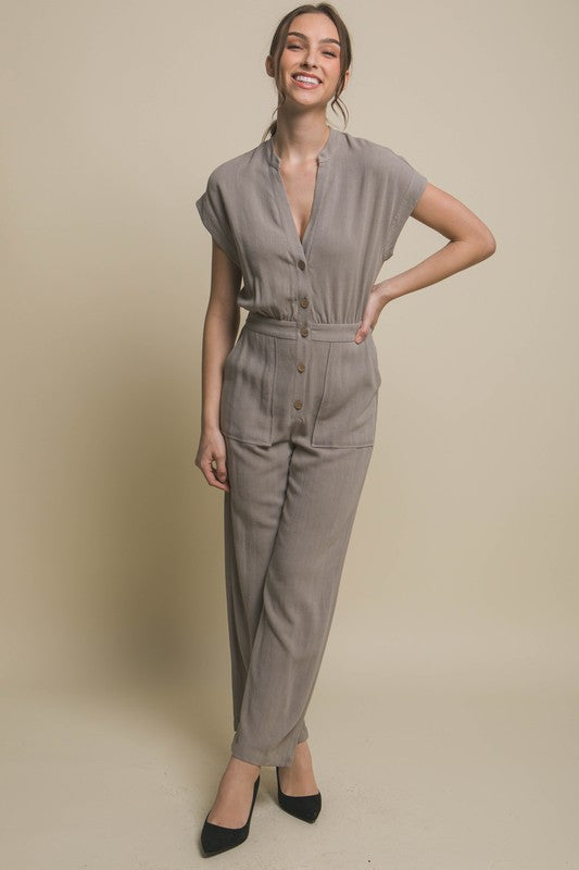 V-Neck Pocketed JumpsuitElevate your casual-chic style with our V-Neck Pocketed Jumpsuit. Crafted for both comfort and style, this jumpsuit features a flattering V-neckline that elongates t