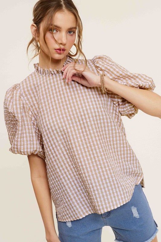 Gingham Check Print Puff Sleeve TopThe Gingham Check Print Puff Sleeve Top exudes femininity and charm with its playful design and swingy silhouette. Crafted from a lightweight and textured gingham ch