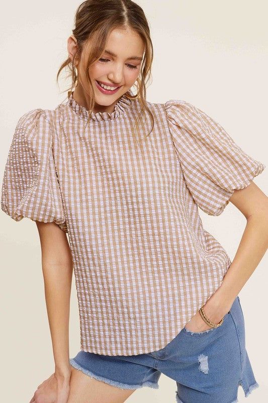 Gingham Check Print Puff Sleeve TopThe Gingham Check Print Puff Sleeve Top exudes femininity and charm with its playful design and swingy silhouette. Crafted from a lightweight and textured gingham ch