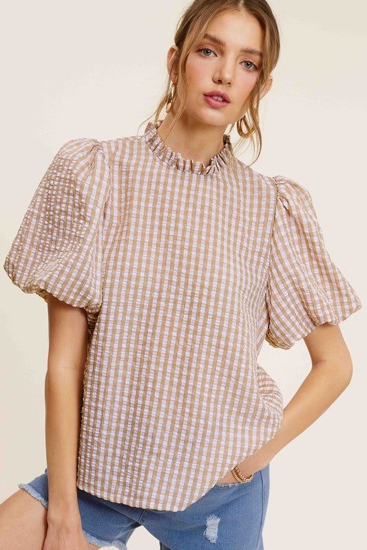 Gingham Check Print Puff Sleeve TopThe Gingham Check Print Puff Sleeve Top exudes femininity and charm with its playful design and swingy silhouette. Crafted from a lightweight and textured gingham ch