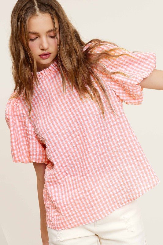 Gingham Check Print Puff Sleeve TopThe Gingham Check Print Puff Sleeve Top exudes femininity and charm with its playful design and swingy silhouette. Crafted from a lightweight and textured gingham ch