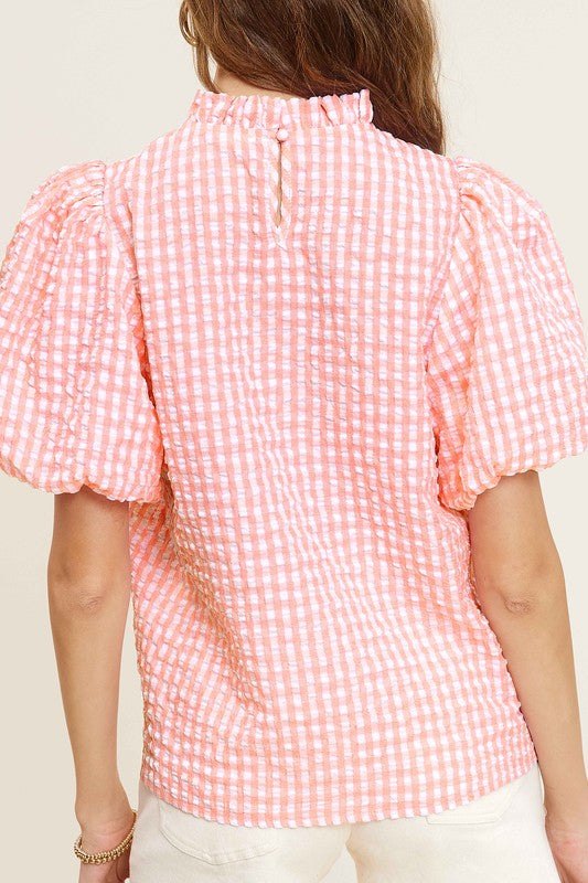 Gingham Check Print Puff Sleeve TopThe Gingham Check Print Puff Sleeve Top exudes femininity and charm with its playful design and swingy silhouette. Crafted from a lightweight and textured gingham ch