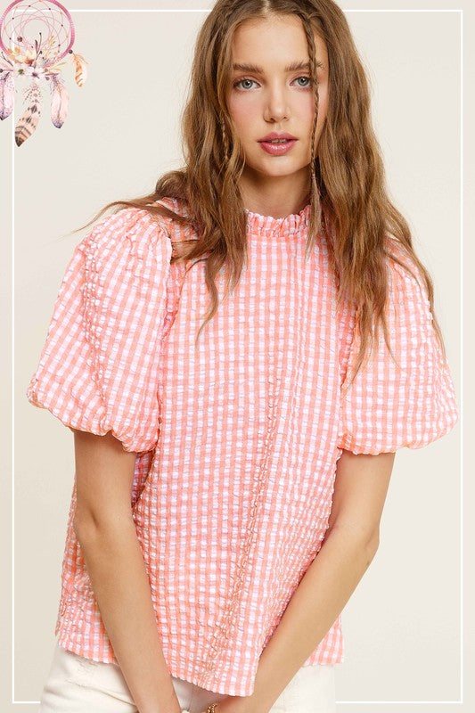 Gingham Check Print Puff Sleeve TopThe Gingham Check Print Puff Sleeve Top exudes femininity and charm with its playful design and swingy silhouette. Crafted from a lightweight and textured gingham ch