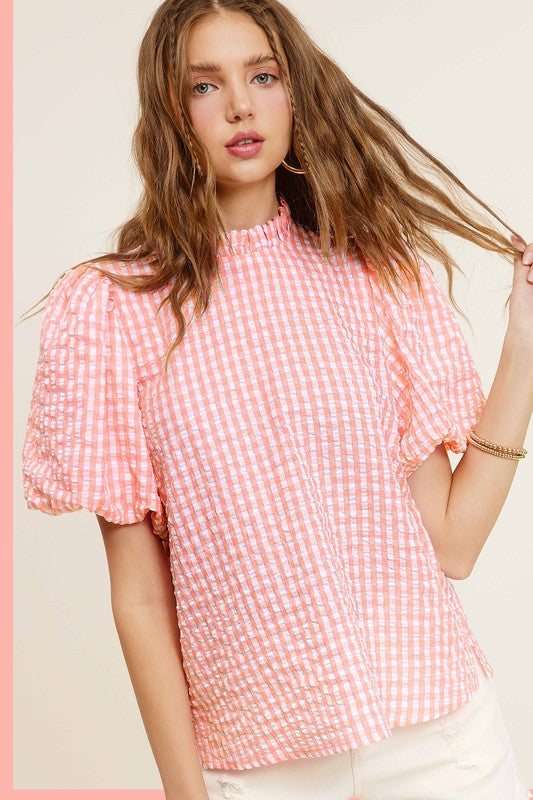 Gingham Check Print Puff Sleeve TopThe Gingham Check Print Puff Sleeve Top exudes femininity and charm with its playful design and swingy silhouette. Crafted from a lightweight and textured gingham ch