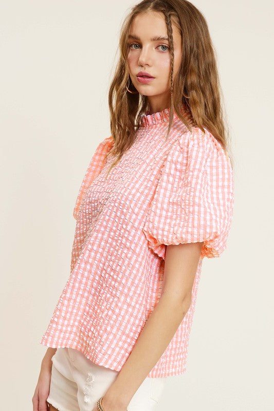 Gingham Check Print Puff Sleeve TopThe Gingham Check Print Puff Sleeve Top exudes femininity and charm with its playful design and swingy silhouette. Crafted from a lightweight and textured gingham ch