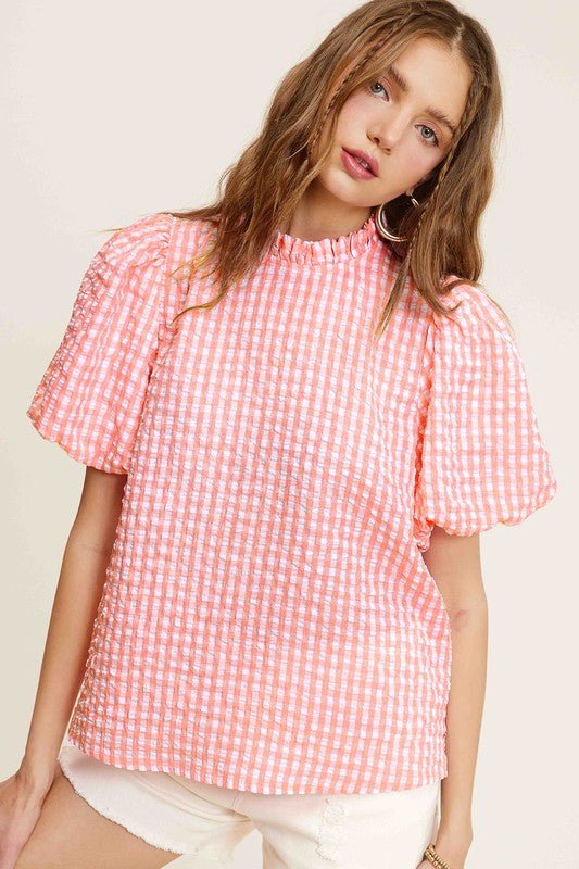 Gingham Check Print Puff Sleeve TopThe Gingham Check Print Puff Sleeve Top exudes femininity and charm with its playful design and swingy silhouette. Crafted from a lightweight and textured gingham ch