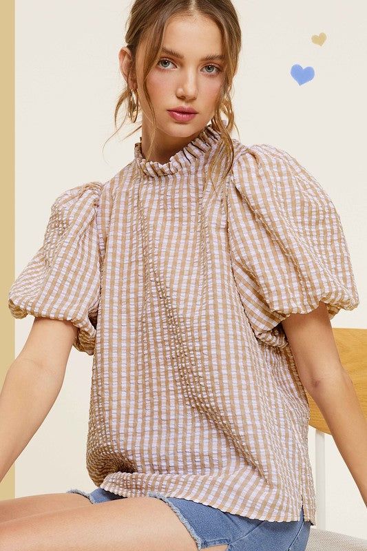 Gingham Check Print Puff Sleeve TopThe Gingham Check Print Puff Sleeve Top exudes femininity and charm with its playful design and swingy silhouette. Crafted from a lightweight and textured gingham ch