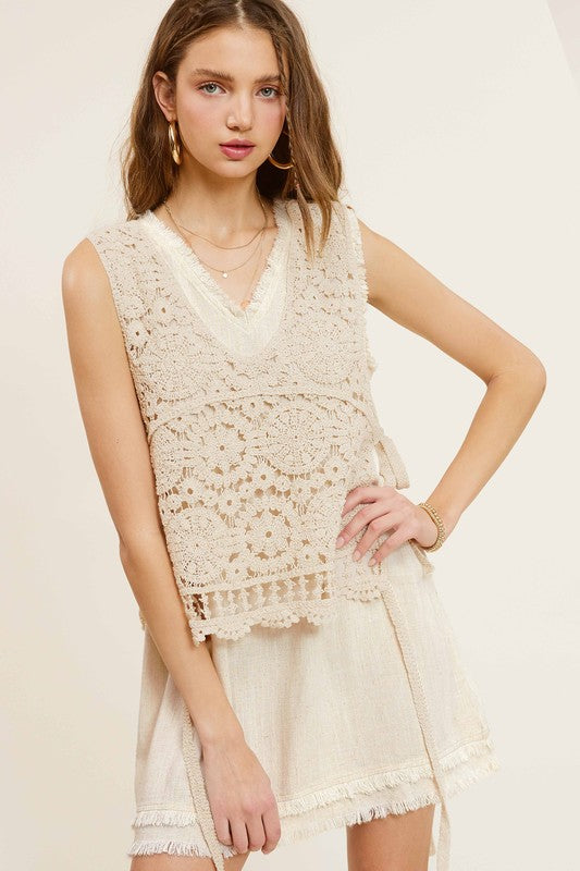 Self Side Tie Detailed Crochet Vest TopStay effortlessly stylish and cool with the Self Side Tie Detailed Crochet Vest Top. This chic addition to your wardrobe features a sleeveless silhouette and a flatt