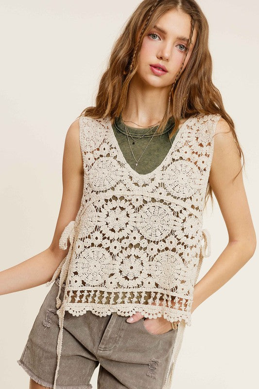 Self Side Tie Detailed Crochet Vest TopStay effortlessly stylish and cool with the Self Side Tie Detailed Crochet Vest Top. This chic addition to your wardrobe features a sleeveless silhouette and a flatt