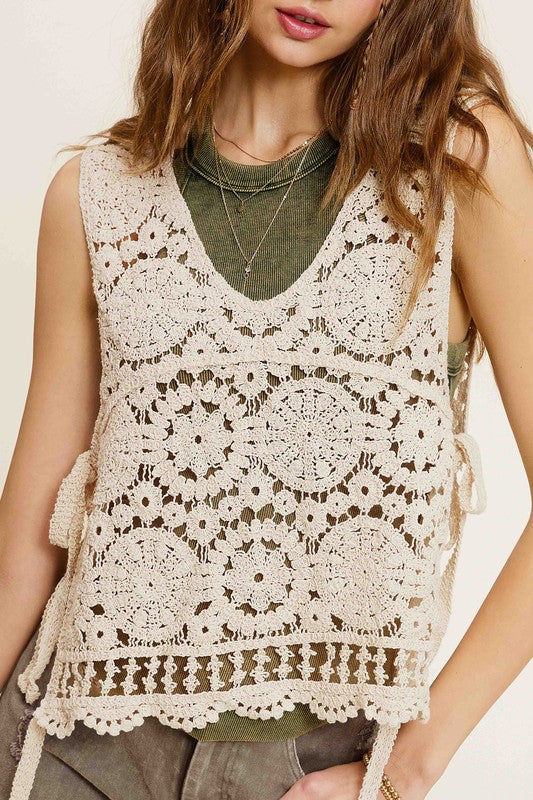 Self Side Tie Detailed Crochet Vest TopStay effortlessly stylish and cool with the Self Side Tie Detailed Crochet Vest Top. This chic addition to your wardrobe features a sleeveless silhouette and a flatt