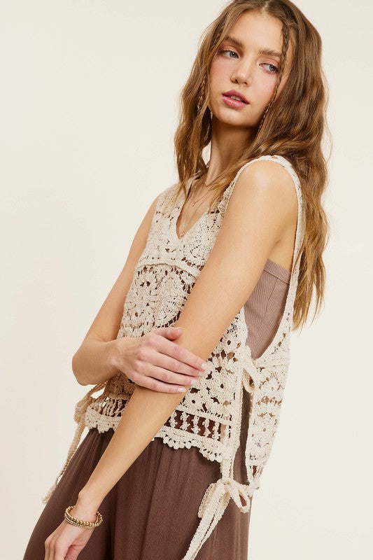 Self Side Tie Detailed Crochet Vest TopStay effortlessly stylish and cool with the Self Side Tie Detailed Crochet Vest Top. This chic addition to your wardrobe features a sleeveless silhouette and a flatt